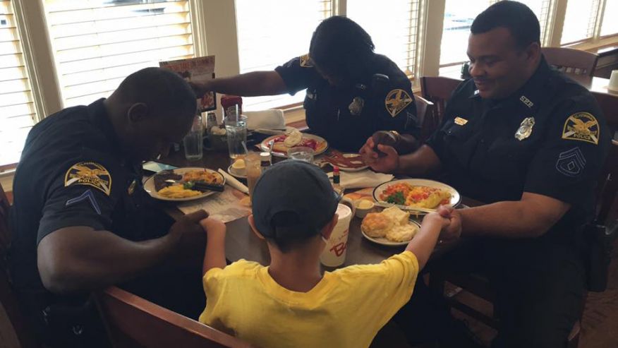 Powerful Photo Shows Boy Praying With Police Officers