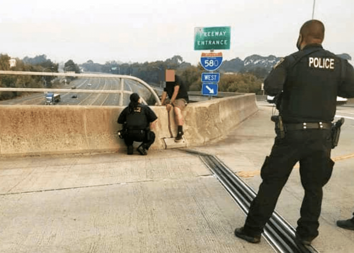 Police talk man from jumping off freeway overpass Law Officer